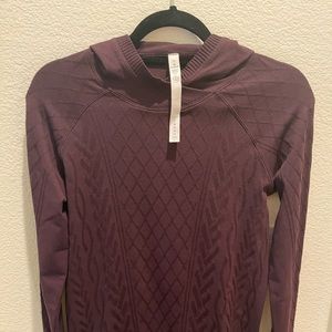 Lululemon plum color stretchy hooded sweater. Size 10.